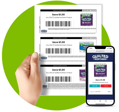 Hand holding printed coupons and phone with digital coupons